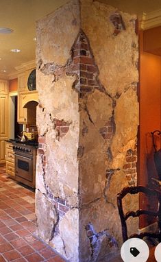 an old brick column in the middle of a kitchen