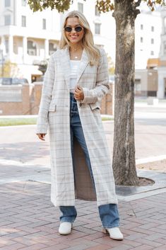 Step into the season in style with the After Fall Tan Plaid Trench Coat, the perfect blend of classic and contemporary design. This trench coat delivers timeless sophistication. The button down front adds versatility, allowing you to layer with ease and wear it open or closed. With its allover plaid pattern, this coat offers a chic, cozy feel, making it a standout piece for your fall wardrobe. It's ideal for layering over casual or dressy outfits, bringing effortless elegance to any look. Spring Long Coat Outerwear With Button Closure, Spring Long Coat With Button Closure, Fall Long Coat With Button Closure, Fall Business Casual Outerwear With Buttons, Long Coat With Snap Buttons For Fall, Business Casual Outerwear With Buttons For Fall, Trendy Long Coat With Double Button, Trendy Notch Lapel Outerwear For Fall, Trendy Winter Outerwear With Hidden Button Closure