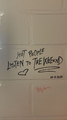 a white brick wall with graffiti written on it that says, hot people listen to the weekend