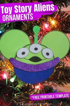 an ornament hanging from a christmas tree with the words toy story aliens ornaments on it