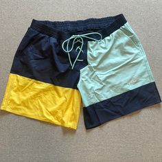 Brand New 7” Board Shorts From Tomboy X. Size 3x. Navy, Turquoise, And Yellow. Green Color Block Beach Bottoms, Green Color Block Bottoms For Beach, Green Color Block Casual Shorts, Green Casual Color Block Shorts, Casual Green Color Block Shorts, Green Color Block Short Bottoms, Sporty Yellow Color Block Bottoms, Yellow Color Block Bottoms For Summer, Blue Color Block Beachwear Bottoms