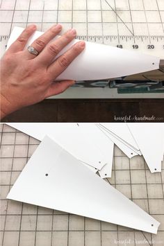 someone is making a paper airplane out of white construction material and cutting it into smaller pieces