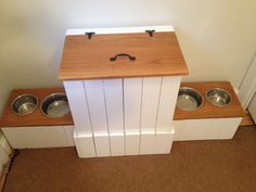 a dog house with two bowls on the floor