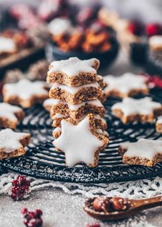 some cookies are stacked on top of each other with icing and cranberries