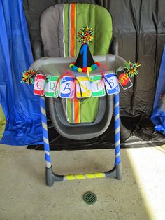 a child's high chair decorated with decorations for a grandads birthday party