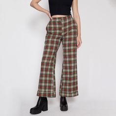 Vintage early 70s red & green plaid knit pants with a high waist, a cuffed flared leg, and a zipper and snap at the waist for closure. Perfect for the holiday season!  Measurements and Condition: Fits like: Women's small to medium (they have been altered at the waist but it is possible to redo it) Fabric: Feels like acrylic Brand: None Condition: Very good, with light general wear, some light pilling to the back inner thighs, and they were taken in at the waist by a previous owner (see close up Retro Wide Leg Bottoms For Fall, Retro Winter Trousers, Retro Fitted Winter Bottoms, Retro Fitted Bottoms For Winter, 70s Inspired Fall Pants, Retro High-waisted Pants For Fall, Fall Retro High-waisted Pants, 70s Inspired Full-length Pants For Fall, 70s Inspired Full-length Fall Pants