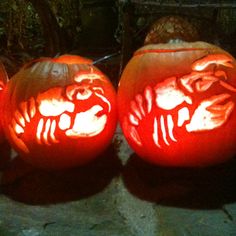 three carved pumpkins sitting on top of a table