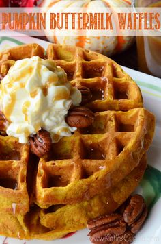 pumpkin buttermilk waffles on a plate with whipped cream and pecans