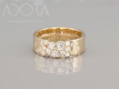 a yellow gold ring with three diamonds on it