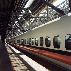 the train is stopped at the station with its doors open and windows on each side