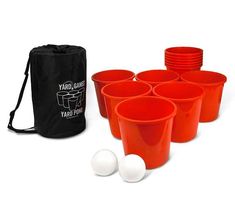 red plastic cups with white balls in front of black drawstring bag and carrying case