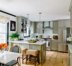 a kitchen filled with lots of counter top space next to a dining room table and chairs