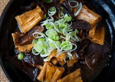 a black bowl filled with food on top of a table