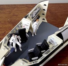 a paper model of a space ship with two people in it