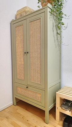 a green cabinet sitting on top of a hard wood floor