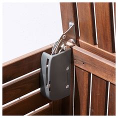 a close up of a wooden chair with a metal latch on it's side