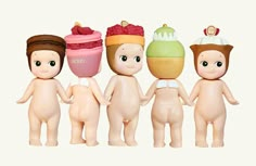 five toy dolls with different types of food on their heads and body, standing in a row