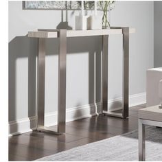 a modern console table with metal legs in a living room