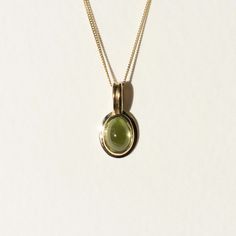 The peridot used for this necklace has a clear olive green hue that maintains it’s vibrant color even in dim lighting. This characteristic is why peridot is often referred to as evening emerald. The pendant is made in 18k gold and comes on an 18” curb chain made in solid 14k gold. Dim Lighting, Green Peridot, Lilac Color, Curb Chain, Rich Color, Olive Green, Lilac, Emerald, 18k Gold