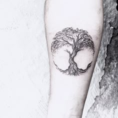 a tree tattoo on the left leg