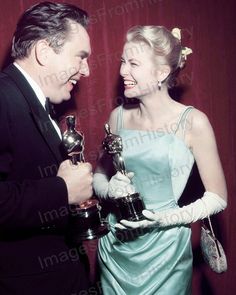 an old photo of a man and woman holding their oscars for best actress in a motion