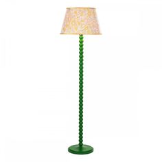 a green floor lamp with a white shade on it's base and a light bulb