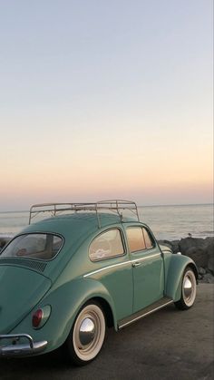 an old vw beetle parked on the beach