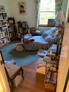 a living room filled with furniture and lots of books