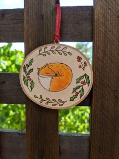 a wooden ornament with an image of a fox on it