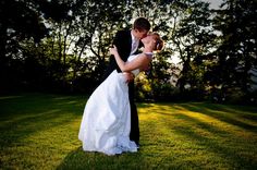 a bride and groom are kissing in the grass at their outdoor wedding ceremony with text overlay