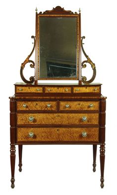 an antique dresser with a mirror on top