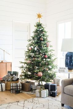 a living room with a christmas tree and presents on the floor