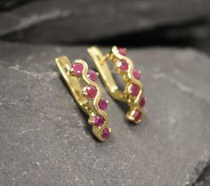 Gold Ruby Earrings set with a Natural Ruby in a diamond cut & natural red color at 3mm each (1.5 Ct a pair) from Burma.Gold Vermeil: 18k Gold over Solid 925 Sterling Silver ☞ made to last.Click here for ☞ Matching RingMatching Pendant ☞ please ask meDetails:• Natural Ruby sourced from Burma• Ruby: 3mm each, 1.5 Ct a pair, round cut• Lever Back Closure - "English Lock"• Dimensions: Length 16mm, Width 4mm• 18k Gold Vermeil❀ Each Natural Gem is unique & will have Slight variations from the product Gold Ruby Earrings, Red Ruby Earrings, Ruby Earrings Studs, Matching Ring, Birthstone Earrings, Real Jewelry, Gold Earrings Designs, Ruby Earrings, Birthstone Earring