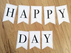 the words happy day are cut out to spell out what's on the table