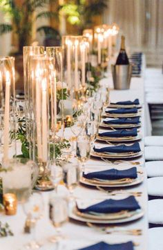 a long table is set with candles and place settings for an elegant dinner or party