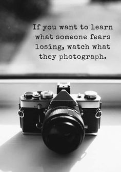 a camera sitting on top of a window sill next to a quote that reads if you want to learn what someone fears, losing, watch what they photography