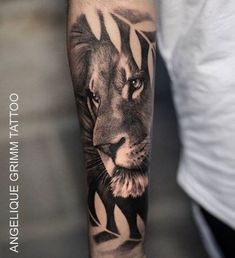 a man with a lion tattoo on his arm