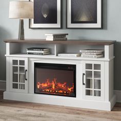 an entertainment center with a fireplace in the middle