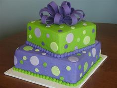 two tiered cake decorated with purple and green polka dots