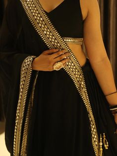 This black georgette lehenga choli set is the epitome of elegance and sophistication. Its detailed embroidery, sequin work, and heavy lace embellishments make it a standout choice for any special occasion.  The ability to customize the choli ensures a perfect fit, while the voluminous lehenga and intricately designed dupatta complete the ensemble, making it a perfect choice for those looking to make a lasting impression.
Complementing the lehenga is a matching choli that maintains the same Black Georgette Sharara For Festive Occasions, Black Georgette Bollywood Sharara, Black Bollywood Style Georgette Sharara, Festive Black Georgette Sharara, Black Georgette Anarkali Set For Navratri, Navratri Black Georgette Anarkali Set, Black Georgette Sharara With Dupatta, Black Pre-draped Saree With Zari Work For Wedding, Black Choli With Sheer Dupatta For Eid