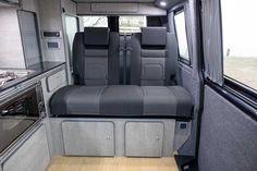 the interior of an rv with grey seats