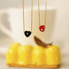 Stunning heart necklace with CZ accent, in black or red. Polished, 18-inch chain and lobster-claw clasp. Pair with a V-neck tee for a chic touch. STONE: Round Cubic Zirconia METAL: Yellow Gold clad Sterling Silver CARAT: About 0.5 carats in total MEASUREMENT: 16” + 2” extender cable chain with lobster claw CODE: JEN20418/ JEP20422 Heart Pendant Necklace, V Neck Tee, Cable Chain, Lobster Claw, Heart Necklace, Heart Pendant, Cubic Zirconia, Black And Red, Cable