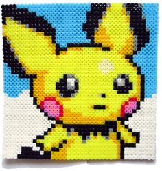 a close up of a piece of art made out of perler beads with a pikachu on it