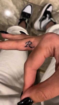 a person's hand with a small tattoo on it