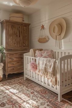 a baby's room with a crib, dresser and hat rack