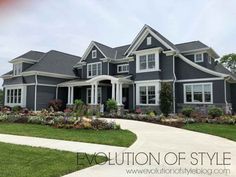 a large gray house with lots of windows