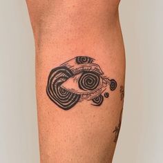 a tattoo on the leg of a person with an eye