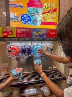 two girls are playing with ice cream machines