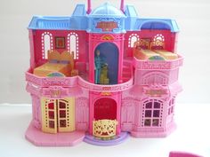 a pink and blue doll house with lots of furniture on it's sides,