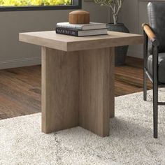 a living room with a chair, table and books on top of the coffee table